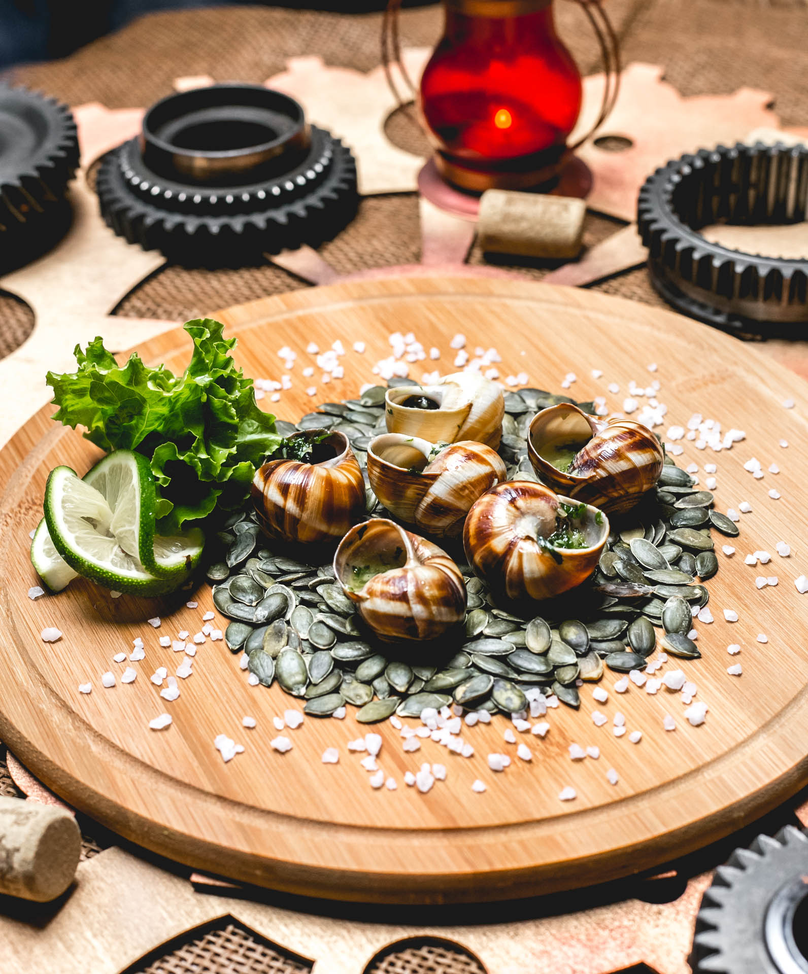 snails-wooden-board-pumpkin-seeds-lime-lettuce-salt-side-view